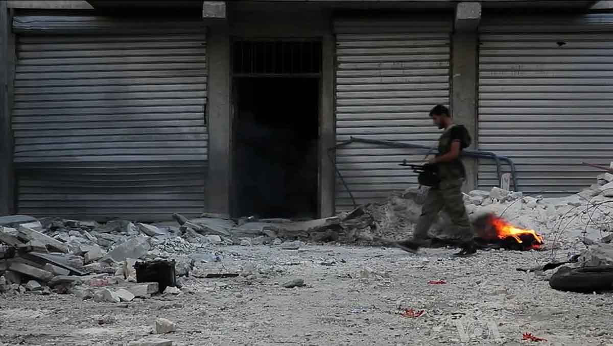 Free_Syrian_Army_soldier_walking_among_rubble_in_Aleppo