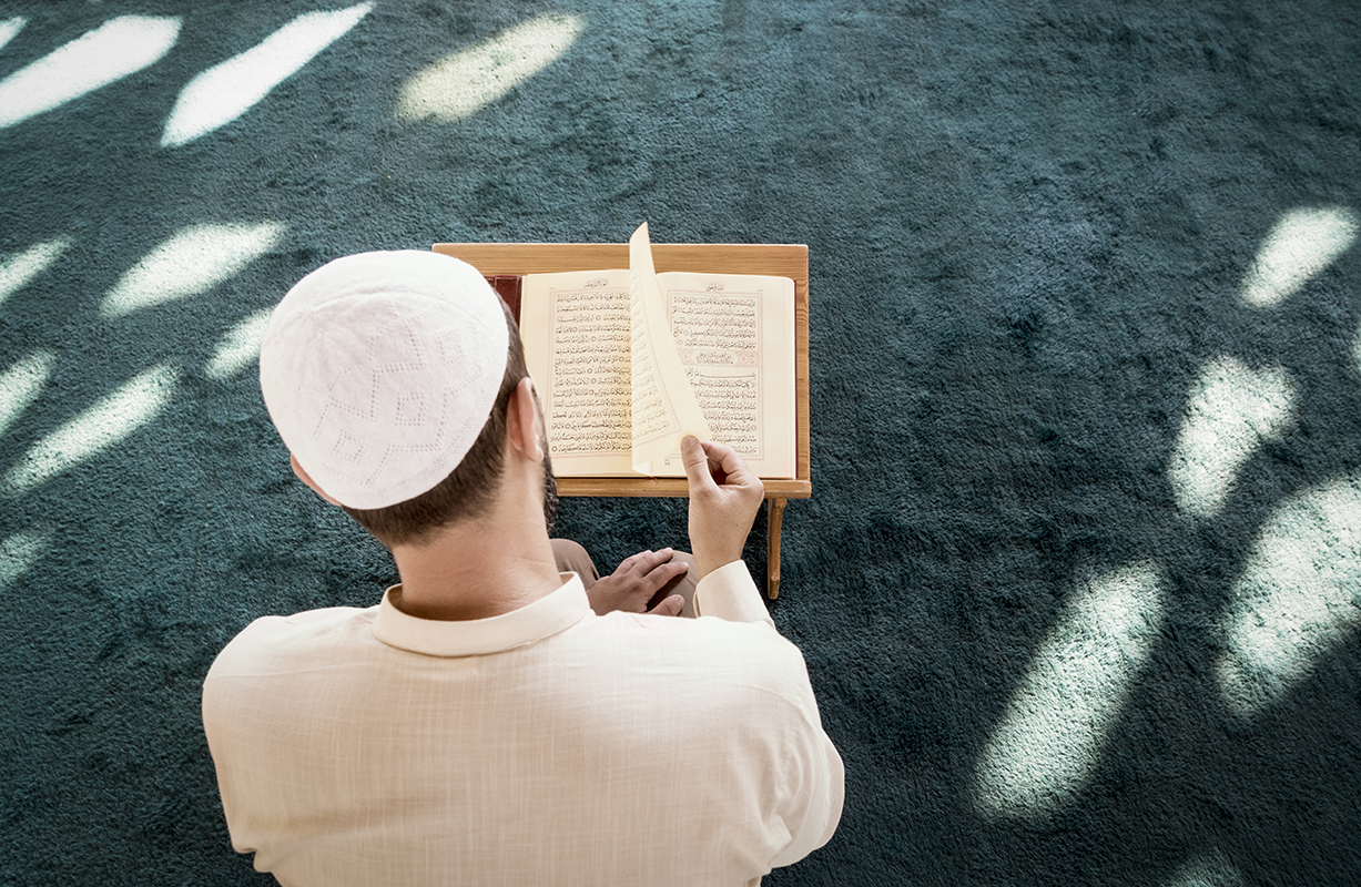 Muslim man is praying in mosque